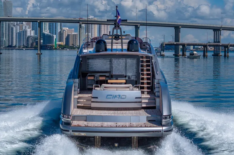Slide: The Image of 2025 Pershing GTX 80 yacht cruising near a city skyline and bridge. - 10