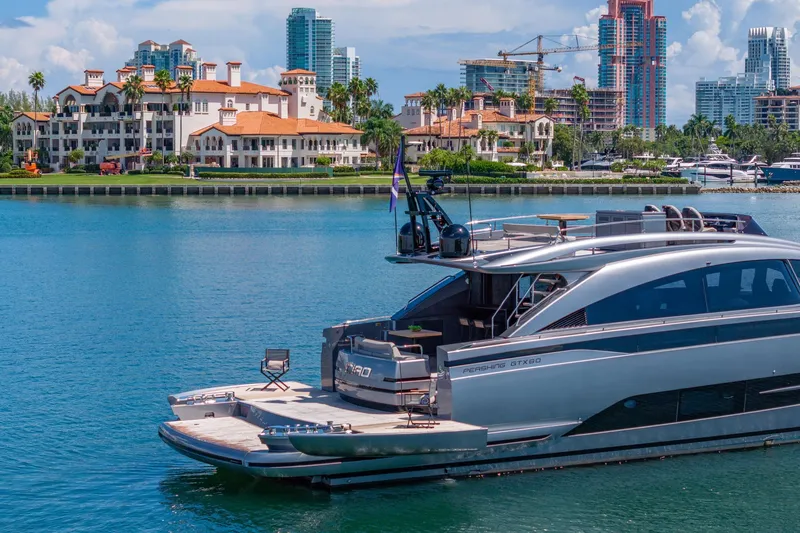 Slide: The Image of Luxury Pershing GTX 80 yacht docked in scenic waterfront setting, 2025 model. - 11