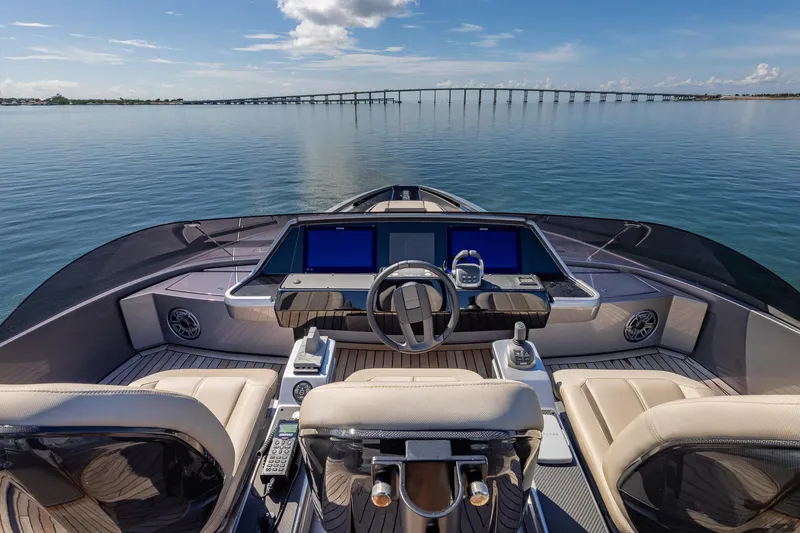 Slide: The Image of 2025 Pershing GTX 80 yacht helm with modern controls and scenic ocean view. - 16
