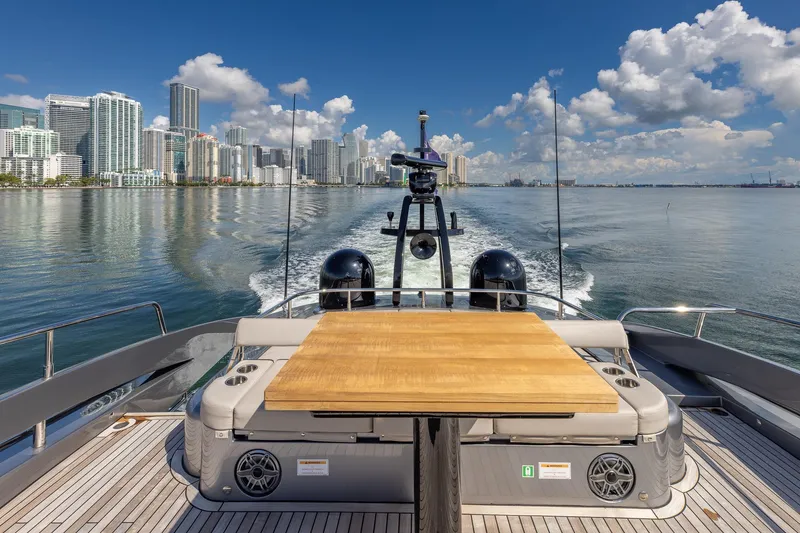 Slide: The Image of 2025 Pershing GTX 80 yacht cruising with city skyline in the background. - 23