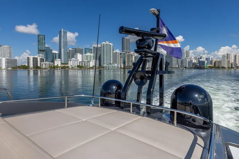 Slide: The Image of 2025 Pershing GTX 80 yacht cruising with city skyline in the background. - 24
