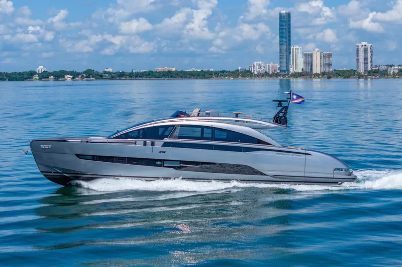 Slide: The Image of 2025 Pershing GTX 80 yacht cruising on a sunny day with city skyline backdrop. - 3