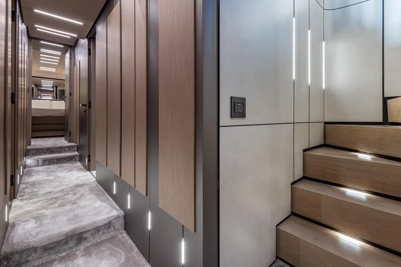 Slide: The Image of Luxurious interior of 2025 Pershing GTX 80 yacht with modern staircase and hallway lighting. - 37