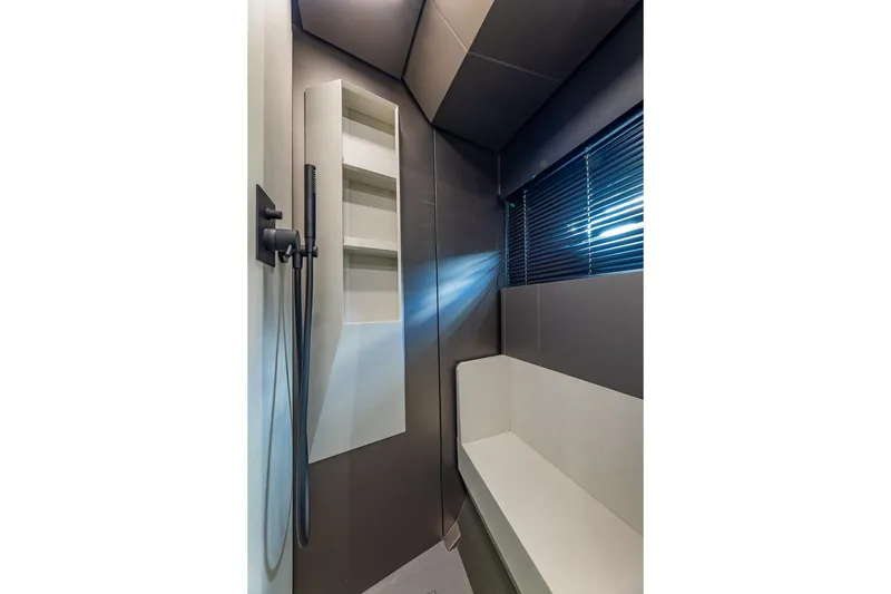 Slide: The Image of Modern bathroom interior on 2025 Pershing GTX 80 yacht, featuring sleek design and built-in shelving. - 47