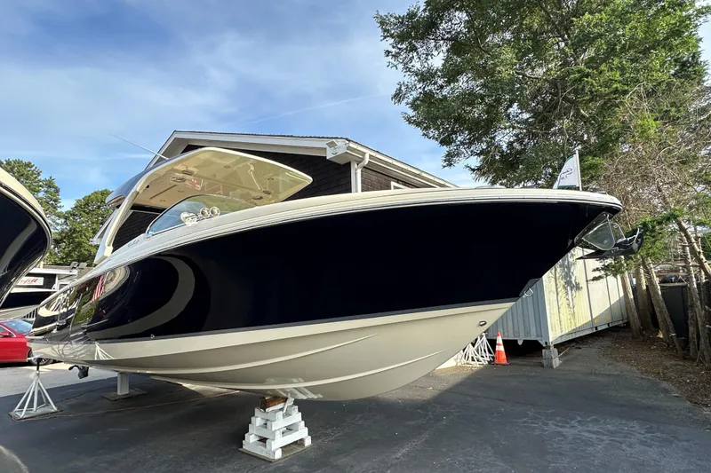 Slide: The Image of 2025 Chris-Craft Launch 31 GT boat displayed outdoors on stands. - 1