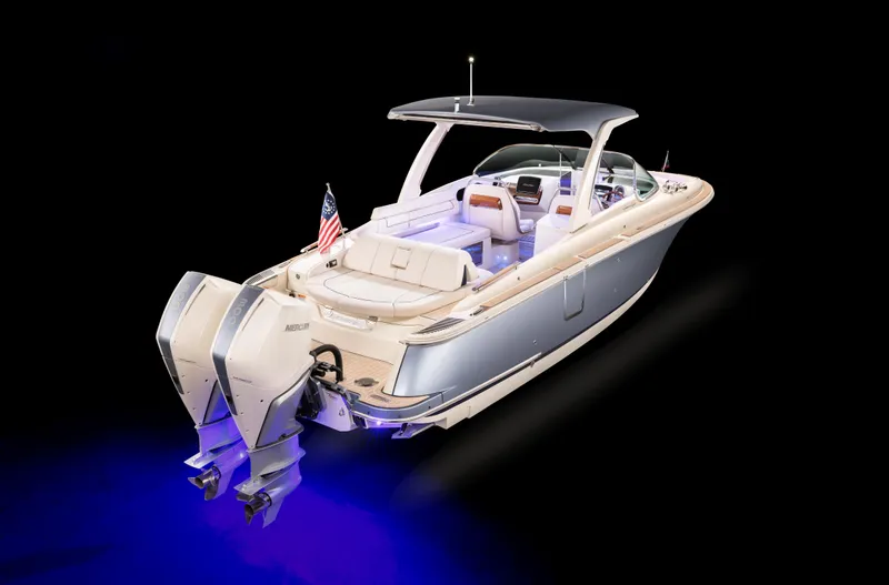 Slide: The Image of 2024 Chris-Craft Launch 31 GT boat with dual outboard engines, illuminated in blue. - 3