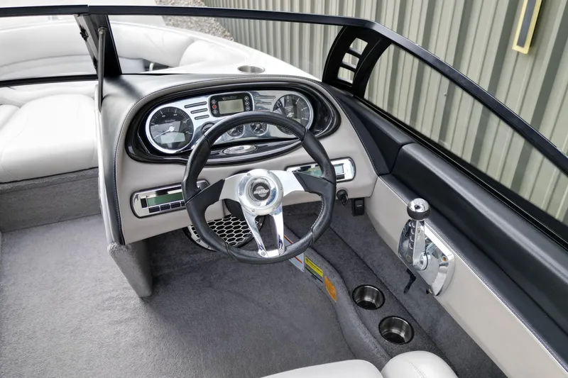 Slide: The Image of 2009 Malibu Wakesetter VTX boat interior with steering wheel and dashboard controls. - 11