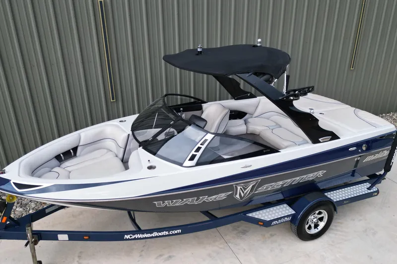 Slide: The Image of 2009 Malibu Wakesetter VTX boat on trailer, featuring sleek design and comfortable seating. - 14