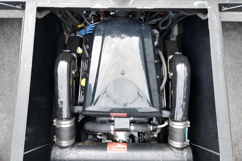 Slide: The Image of Engine compartment of a 2009 Malibu Wakesetter VTX boat, showcasing its powerful motor. - 16