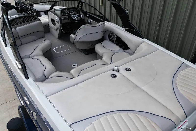 Slide: The Image of 2009 Malibu Wakesetter VTX boat interior with gray seating and sleek design. - 8