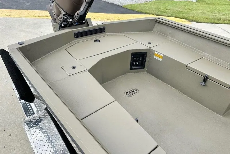 Slide: The Image of 2026 Thor 1754 Timber Hammer boat interior with storage compartments and control panel. - 3