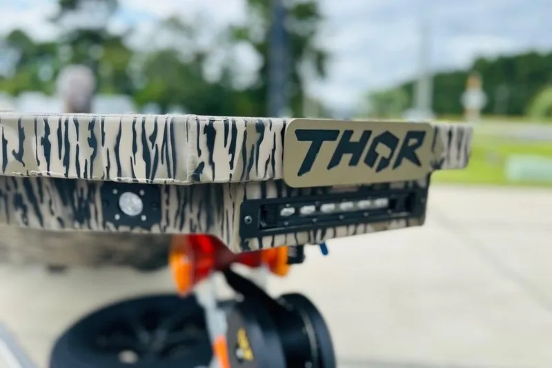 Slide: The Image of 2026 Thor 1754 Timber Hammer with camouflage design and logo, featuring LED lights. - 8