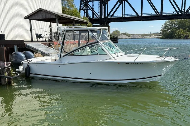 Slide: The Image of 2019 Albemarle 25 Express boat docked by a riverside structure. - 1