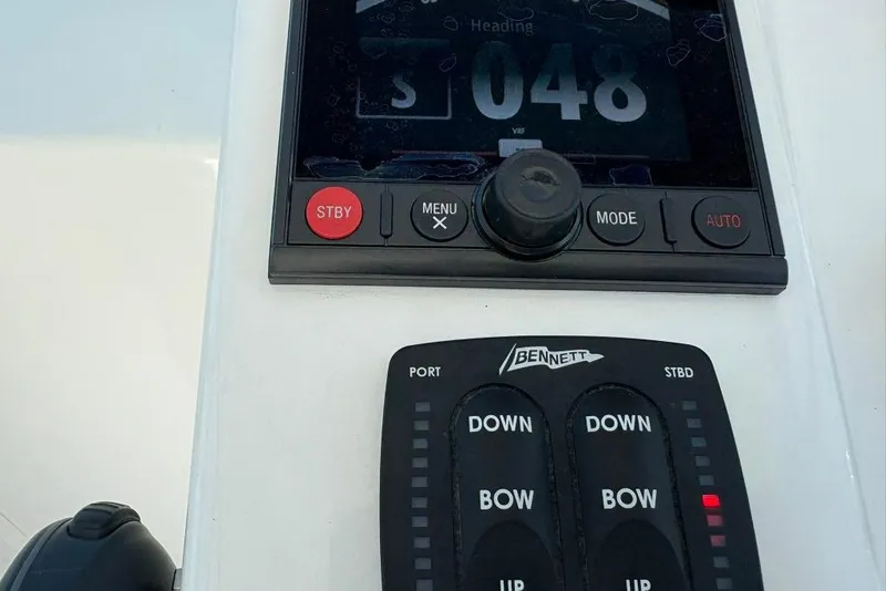 Slide: The Image of Control panel of a 2019 Albemarle 25 Express boat, featuring navigation and trim controls. - 10