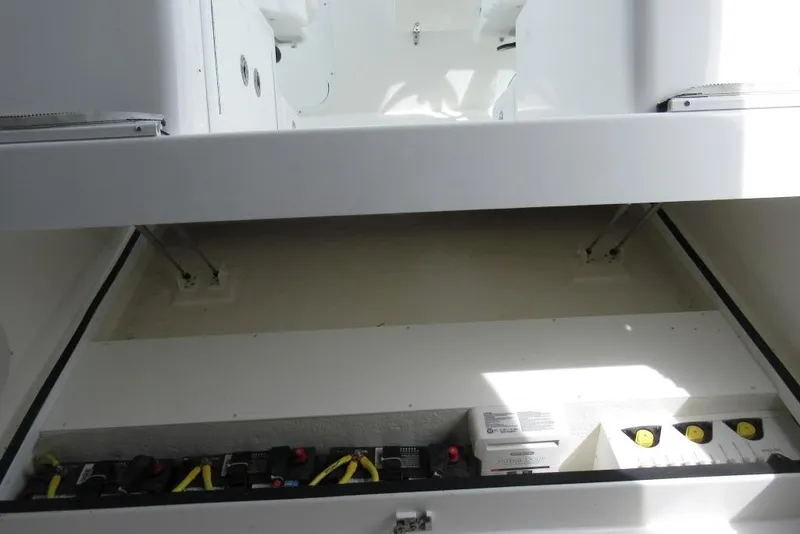 Slide: The Image of 2019 Albemarle 25 Express boat interior showing storage compartment and electrical components. - 15