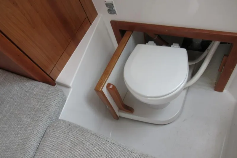 Slide: The Image of 2019 Albemarle 25 Express boat interior with compact marine toilet setup. - 17