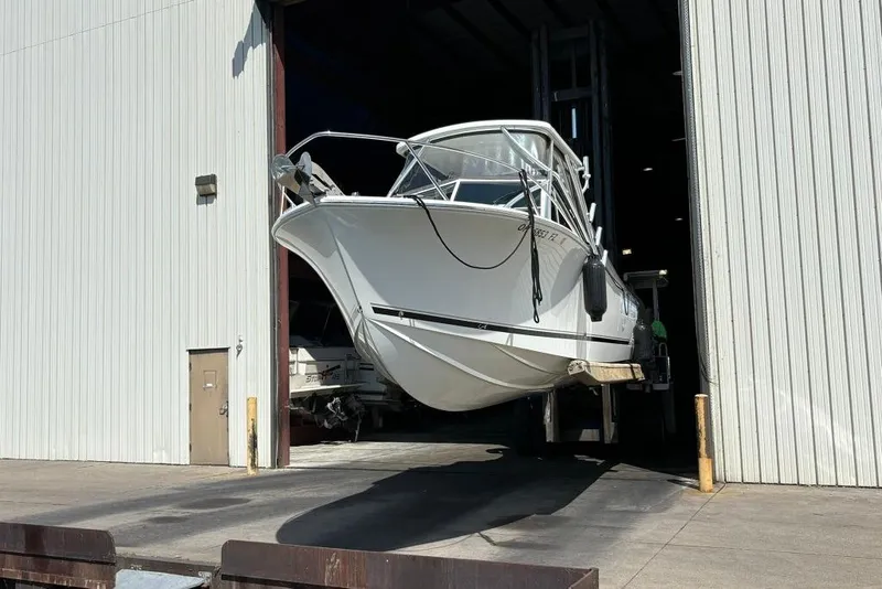 Slide: The Image of 2019 Albemarle 25 Express boat exiting large storage facility. - 2