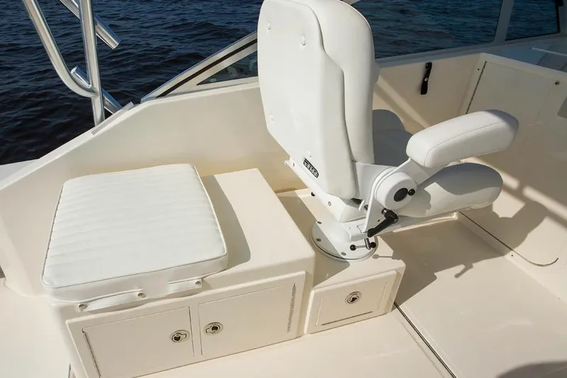 Slide: The Image of Manufacturer Provided Image: 2019 Albemarle 25 Express boat interior with white seating and storage compartments. - 25