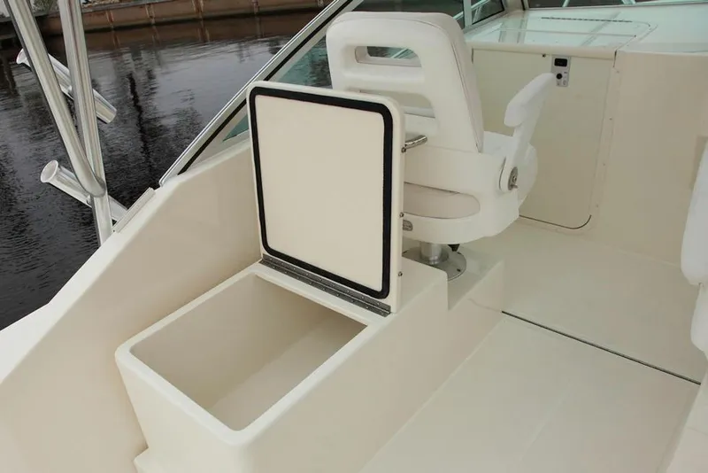 Slide: The Image of Manufacturer Provided Image: 2019 Albemarle 25 Express boat interior with open storage compartment and captain's chair. - 26