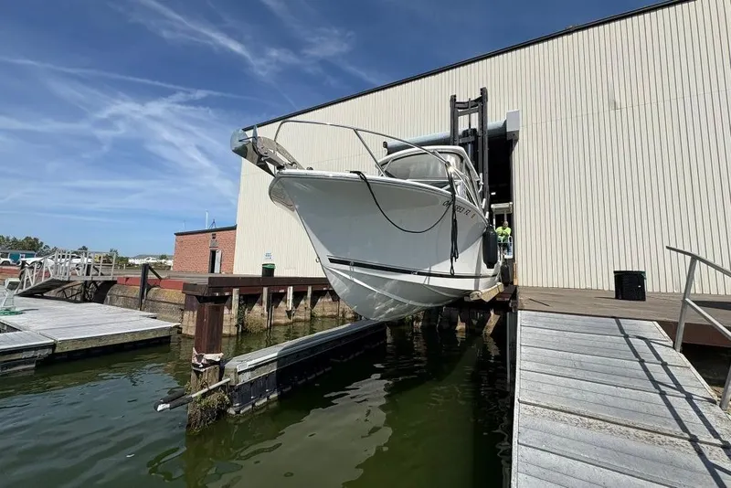 Slide: The Image of 2019 Albemarle 25 Express boat being launched from a dockside facility. - 3
