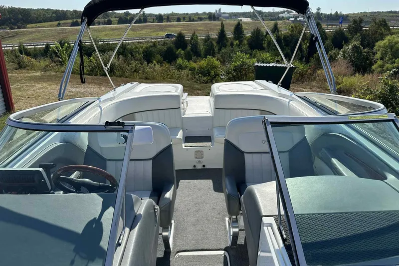 Slide: The Image of 2005 Cobalt 262 boat interior with seating and steering wheel, set against a scenic landscape. - 1