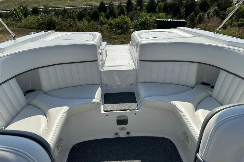 Slide: The Image of 2005 Cobalt 262 boat interior with white leather seating and cup holders. - 13