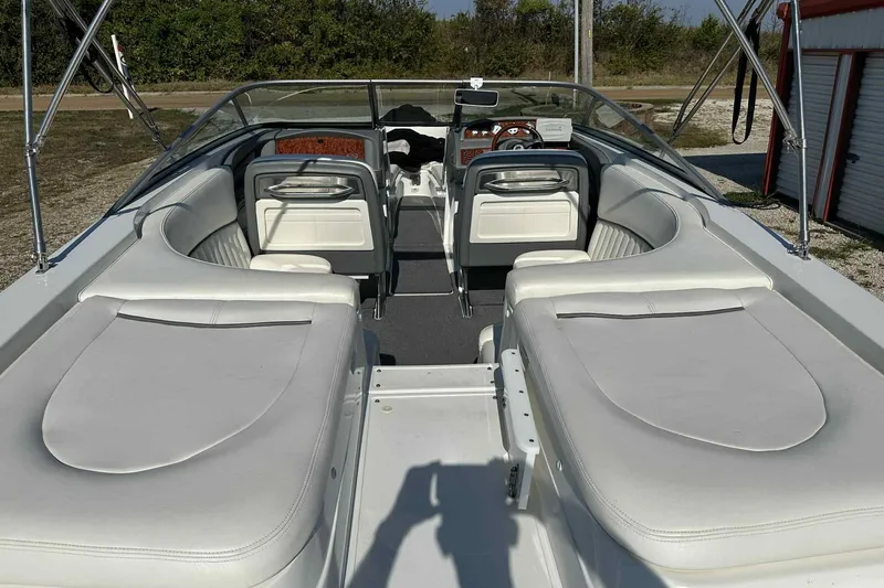 Slide: The Image of 2005 Cobalt 262 boat interior with white seating and open cockpit design. - 14