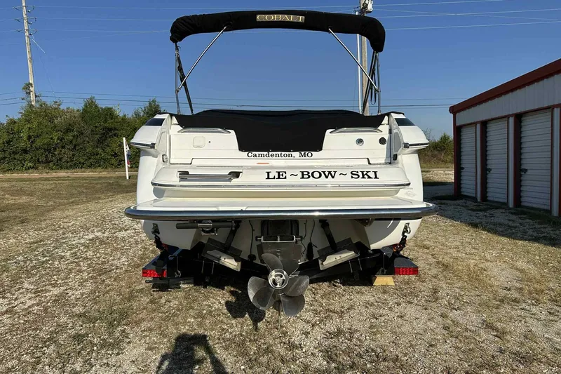 Slide: The Image of Rear view of a 2005 Cobalt 262 boat named "Le~Bow~Ski" in a storage area. - 7