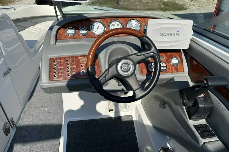 Slide: The Image of 2005 Cobalt 262 boat dashboard with Garmin GPS and wood accents. - 8