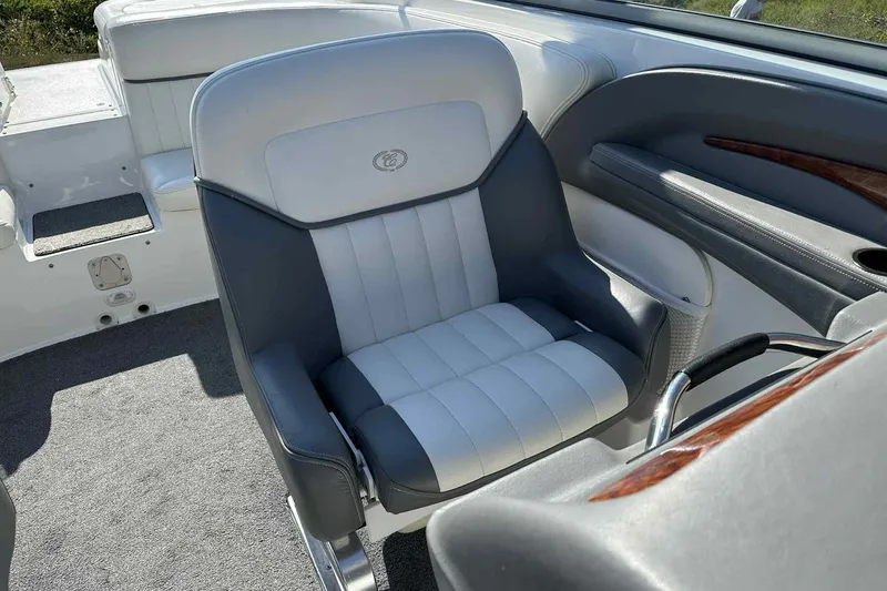 Slide: The Image of Captain's chair in a 2005 Cobalt 262 boat, featuring white and gray upholstery. - 9