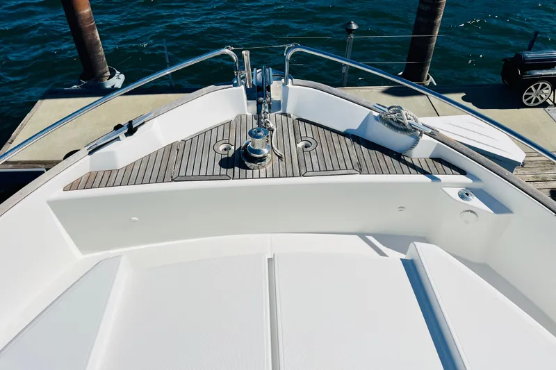 Slide: The Image of Bow of 2014 Beneteau Swift Trawler 50 with teak decking at dock. - 13