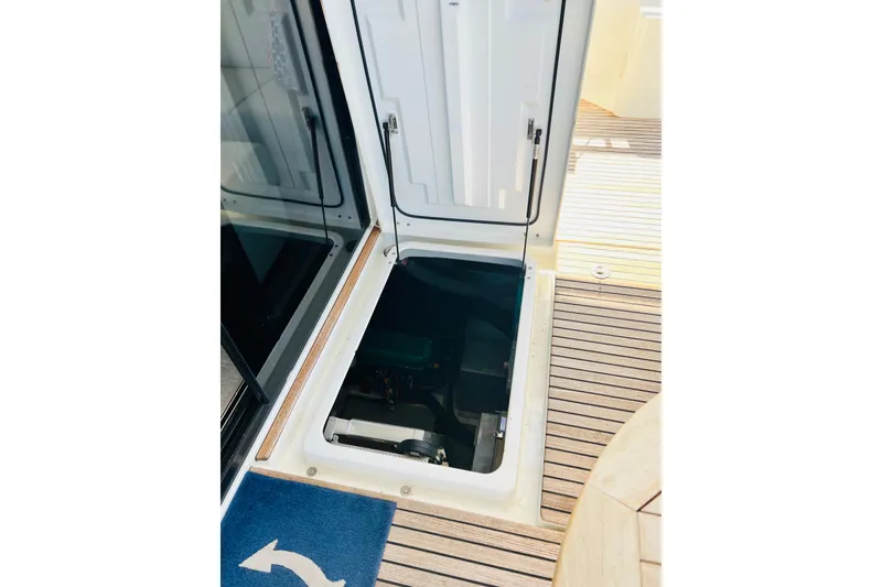 Slide: The Image of Engine compartment access on 2014 Beneteau Swift Trawler 50, featuring teak deck. - 16