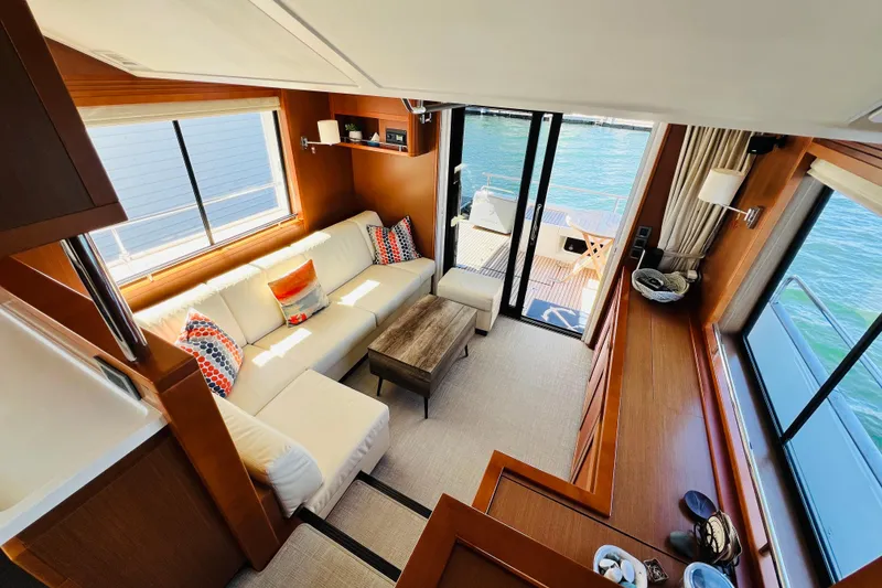 Slide: The Image of Luxurious interior of 2014 Beneteau Swift Trawler 50 with elegant seating and waterfront view. - 23