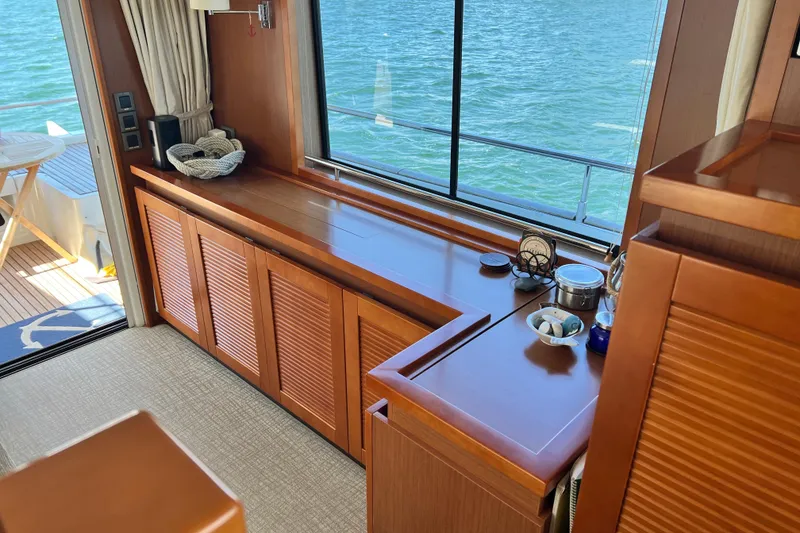 Slide: The Image of Luxurious interior of 2014 Beneteau Swift Trawler 50 with wooden cabinetry and ocean view. - 24