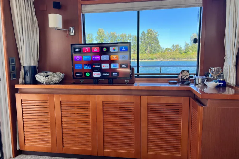 Slide: The Image of Interior of 2014 Beneteau Swift Trawler 50 with TV and scenic window view. - 26