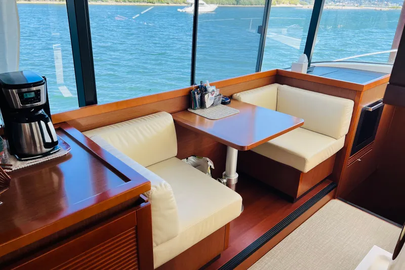Slide: The Image of Interior of 2014 Beneteau Swift Trawler 50 with dining area and coffee maker. - 27