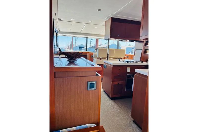 Slide: The Image of Interior of 2014 Beneteau Swift Trawler 50, featuring modern kitchen and seating area. - 28