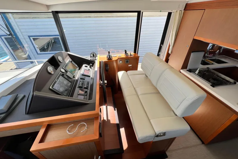 Slide: The Image of Interior helm of 2014 Beneteau Swift Trawler 50 with modern controls and seating. - 29