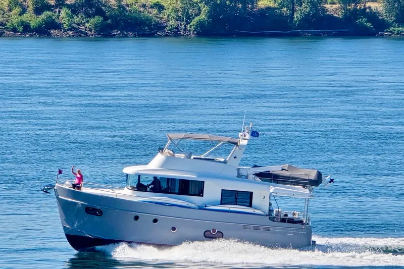 Slide: The Image of 2014 Beneteau Swift Trawler 50 cruising on a serene blue lake. - 3