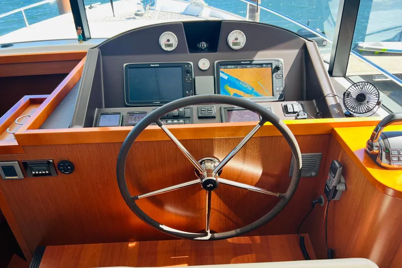 Slide: The Image of Helm of 2014 Beneteau Swift Trawler 50 with navigation equipment and steering wheel. - 30