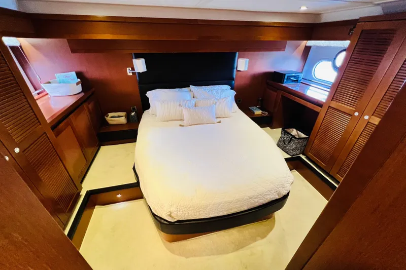 Slide: The Image of Luxurious bedroom in 2014 Beneteau Swift Trawler 50 yacht, featuring elegant wood finishes. - 35