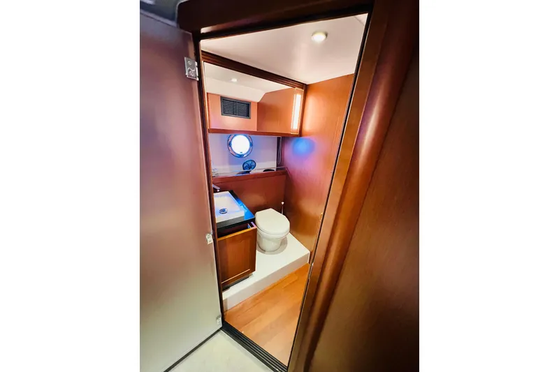 Slide: The Image of 2014 Beneteau Swift Trawler 50 bathroom with wooden interior and modern fixtures. - 37