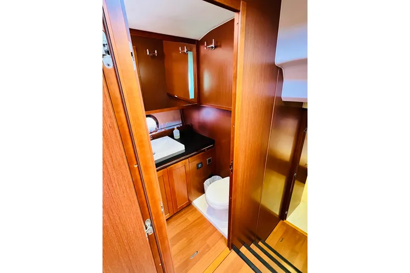 Slide: The Image of 2014 Beneteau Swift Trawler 50 bathroom with wooden cabinetry and modern fixtures. - 38