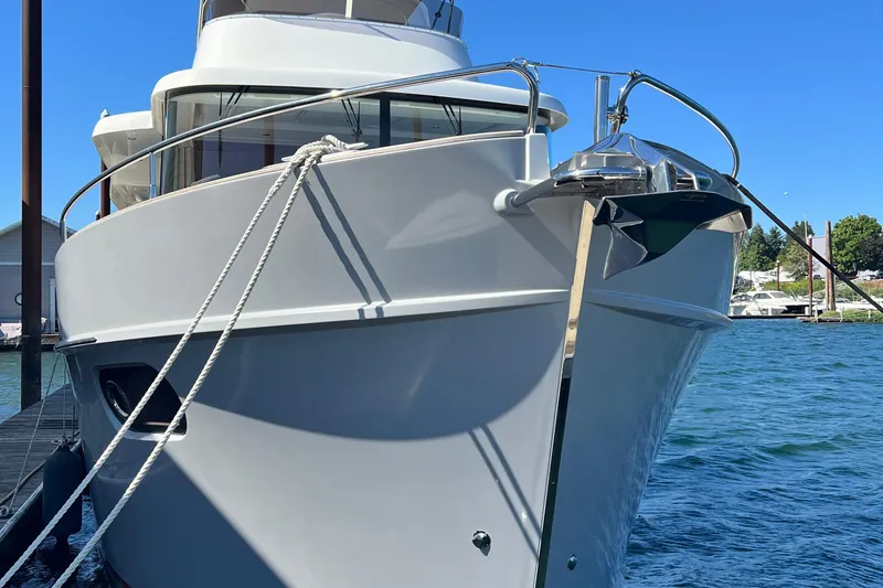 Slide: The Image of 2014 Beneteau Swift Trawler 50 docked, showcasing sleek design and nautical elegance. - 4