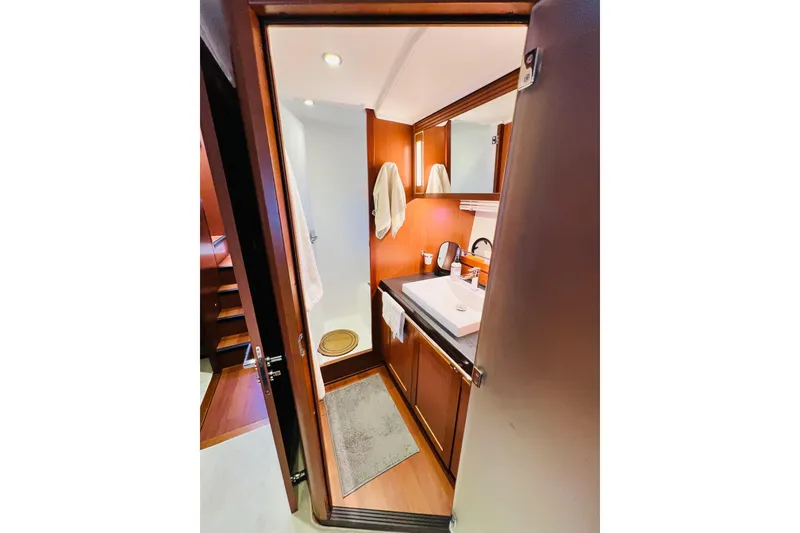 Slide: The Image of 2014 Beneteau Swift Trawler 50 bathroom with wooden cabinetry and modern fixtures. - 42