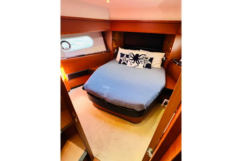 Slide: The Image of Luxurious cabin interior of 2014 Beneteau Swift Trawler 50 with cozy bed and nautical decor. - 43