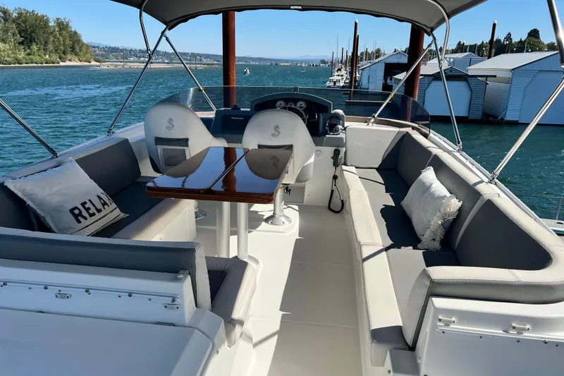 Slide: The Image of Luxurious 2014 Beneteau Swift Trawler 50 with spacious seating and scenic waterfront view. - 47