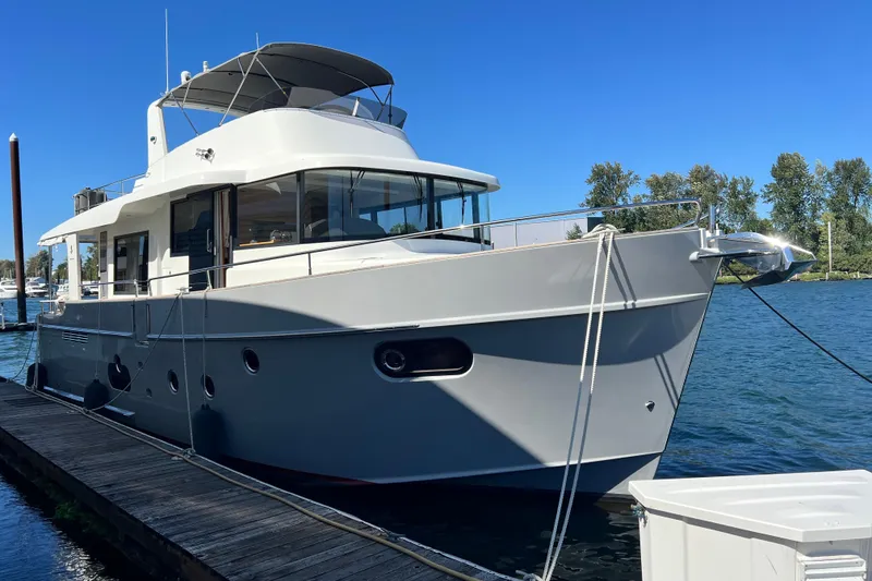Slide: The Image of 2014 Beneteau Swift Trawler 50 docked on a sunny day, showcasing sleek design and modern features. - 5