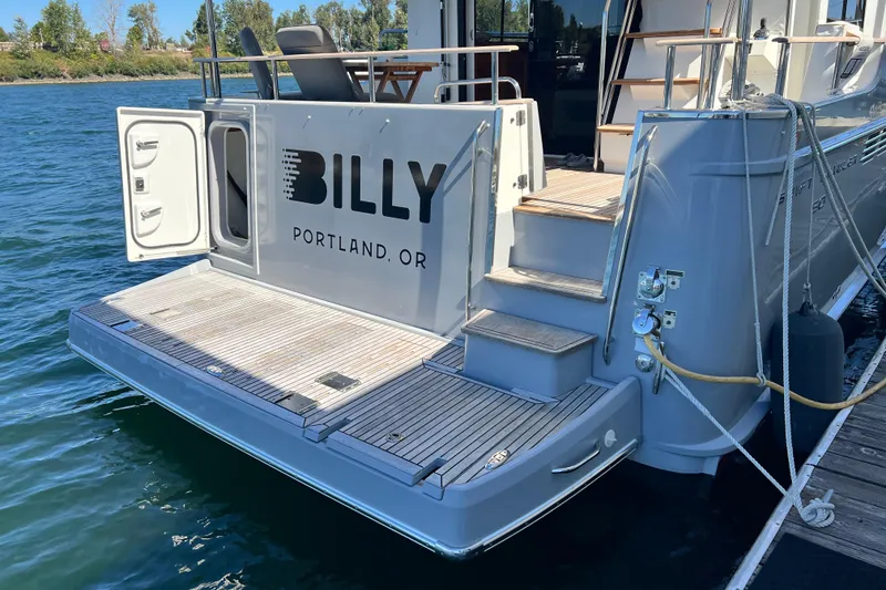 Slide: The Image of 2014 Beneteau Swift Trawler 50 docked, featuring "BILLY" from Portland, OR on the stern. - 7