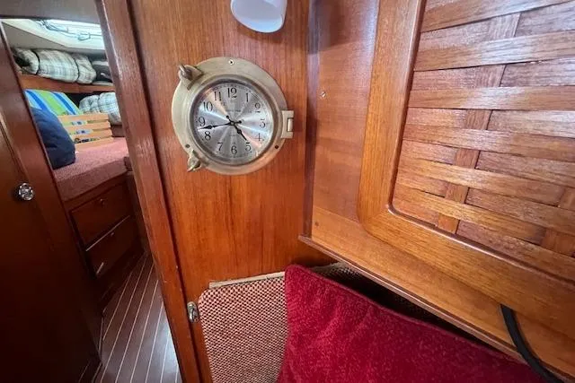 Slide: The Image of Interior of 1987 Sabre 42 K/CB yacht with wooden paneling and brass clock. - 12